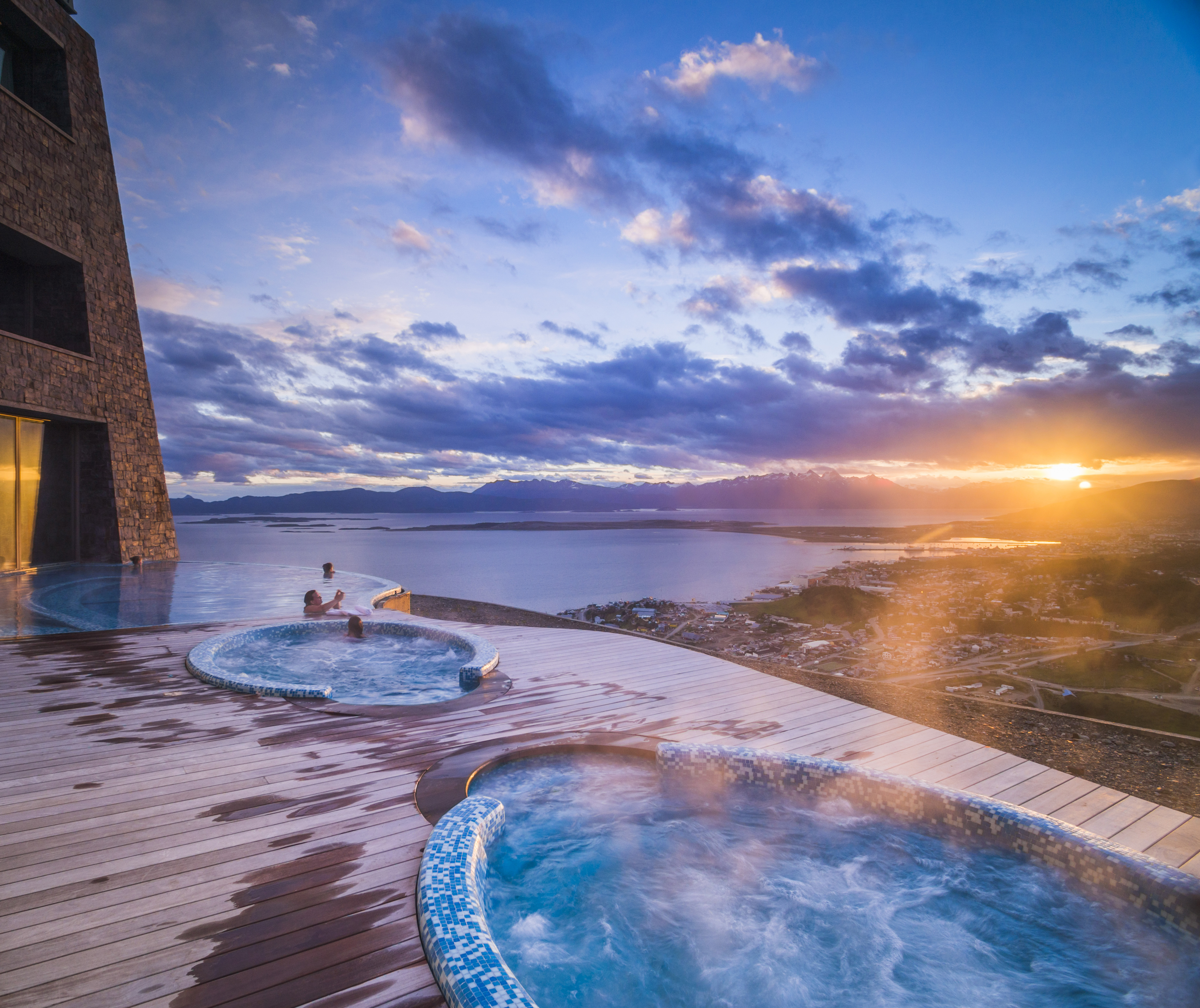 Outdoor swimming pool and jacuzzi at sunset